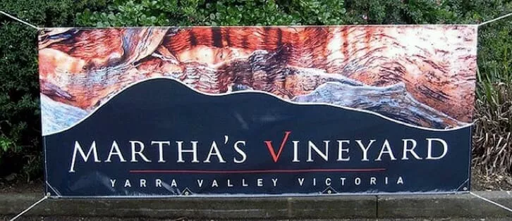 Banner for "Martha’s Vineyard" in Yarra Valley, Victoria. Text over scenic abstract landscape in rich earthy tones, set against a leafy background.