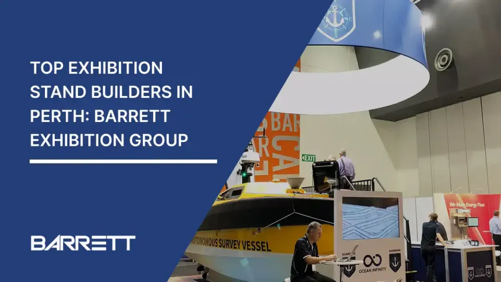 Exhibition stand featuring Barrett Exhibition Group branding, showcasing a yellow autonomous survey vessel and various displays.