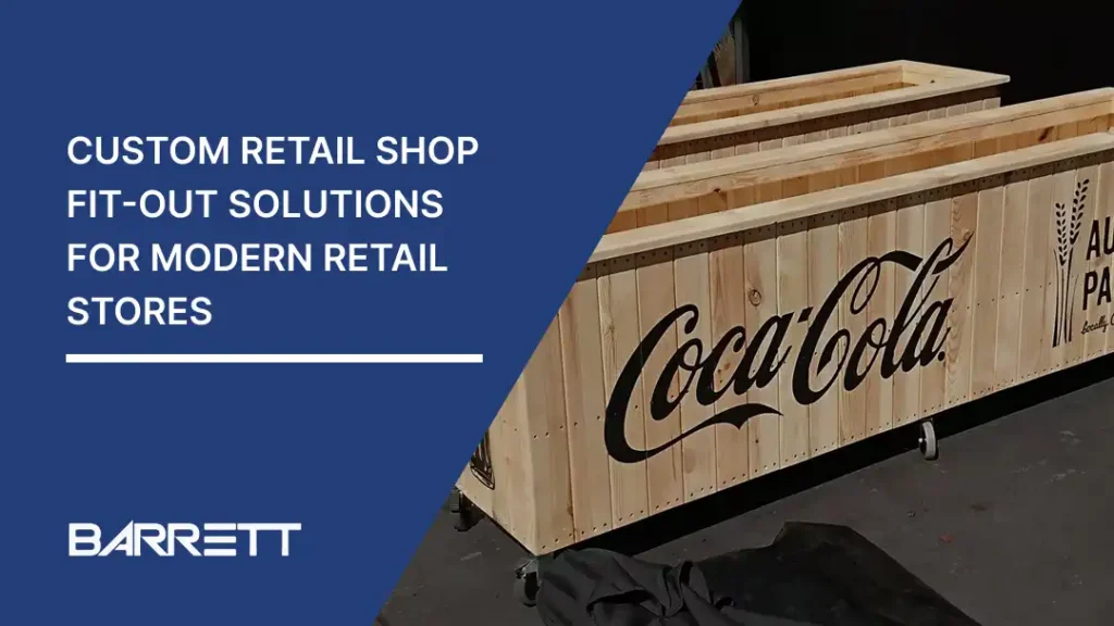 Custom retail shop fit-out solutions banner with wooden Coca-Cola display counters & Barrett logo.