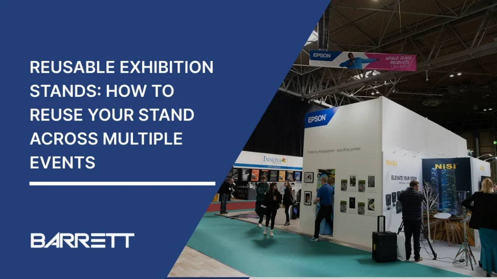 A Barrett Exhibition Group banner showing a large modular exhibition stand at a busy trade show, with exhibitors and visitors walking around the display. The stand features branded walls, product displays and open spaces, illustrating how an exhibition stand can be reused across multiple events.